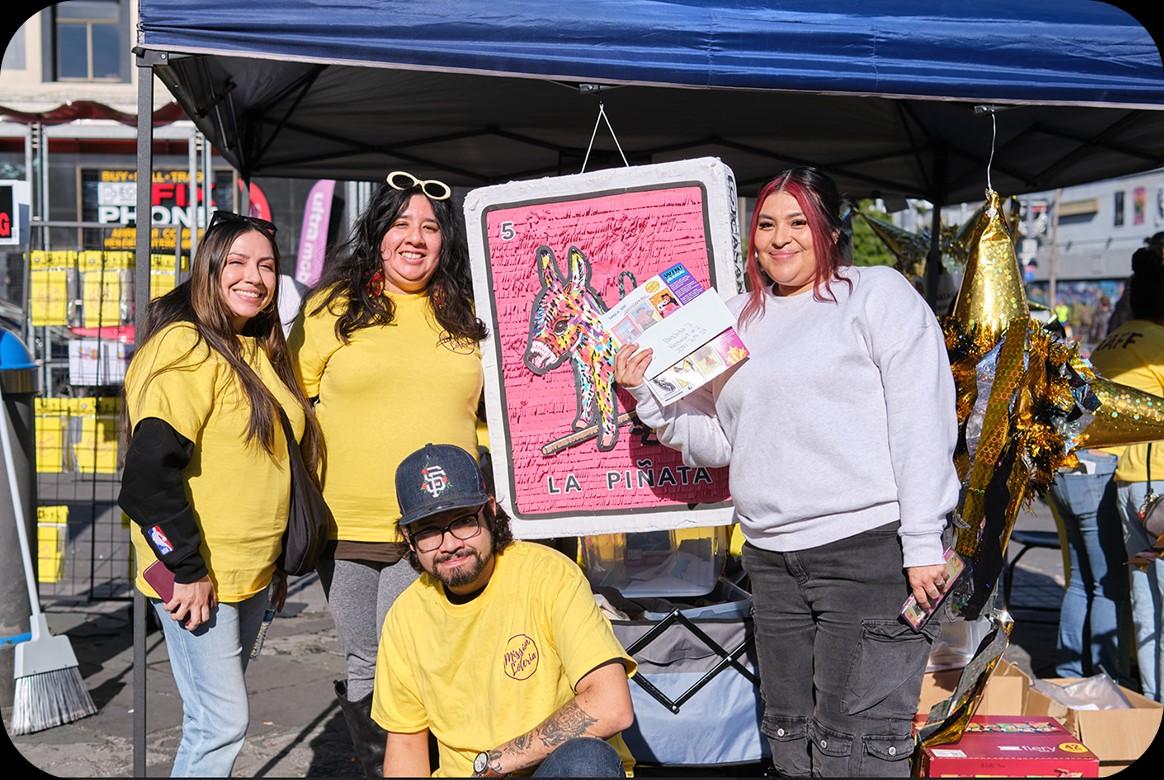Mission Lotería team celebrating los Reyes Magos at a Mission District event